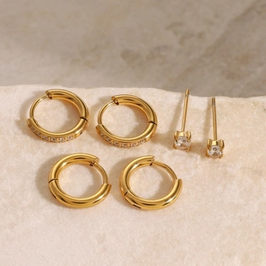 Detailed view of three pairs of gold-plated stainless steel earrings with cubic zirconia