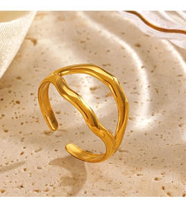 Close-up of a 18K gold-plated irregular wave open ring on a natural stone surface