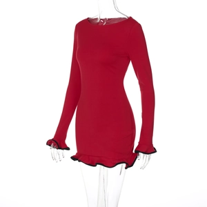 Detailed view of red long sleeve dress featuring ruffle hem and black contrast piping