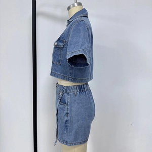 Detail of blue denim two-piece set with short sleeve crop top and matching mini skirt