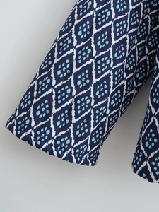 Detailed macro view of navy blue quilted sleeve with geometric diamond prints