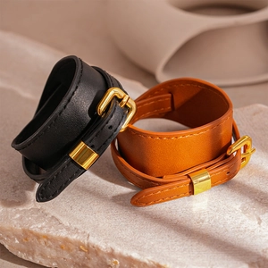 Minimalist wide faux leather belt buckle bracelets in black and brown with gold metal hardware