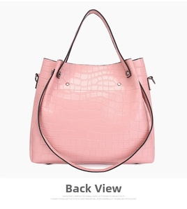 Detailed back view of pink crocodile pattern faux leather tote bag with rivet accents