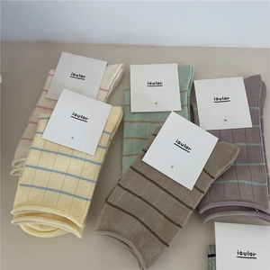 Flat lay of colorful ribbed cotton socks in Morandi tones with clean white labels