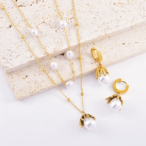 Elegant gold pearl jewelry set featuring double layer necklace and hoop earrings