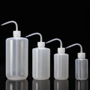 Set of four translucent plastic squeeze wash bottles with curved nozzles and blue scales
