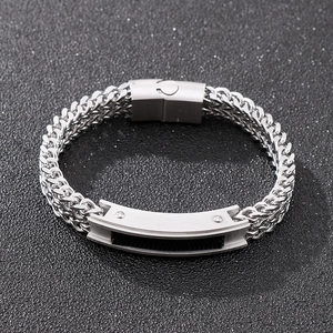 Detail of silver stainless steel woven chain bracelet with brushed magnetic clasp