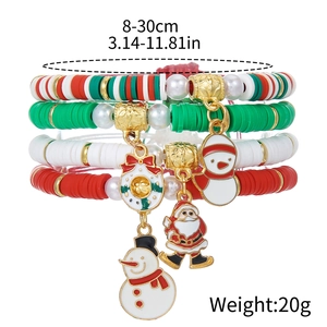 Détails des bracelets de Noël en argile rouge, verte et blanche avec des breloques