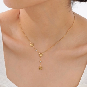 Elegant gold stainless steel Y-necklace with zircon flower pendants on a model