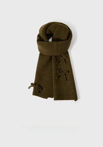 Detailed close-up of olive green knitted scarf featuring a decorative bow knot detail