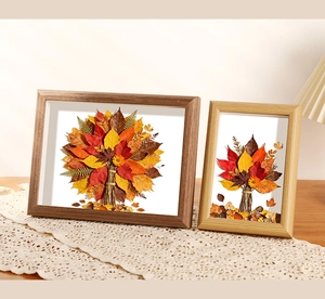 Macro detail of wooden shadow box frame featuring 3D autumn leaf specimen art on lace