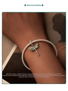 Détail d'un pendentif libellé avec pierres vertes sur un bracelet en maille argentée