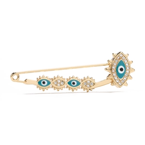 Detailed view of 18K gold plated safety pin brooch with blue evil eye charms and zircons