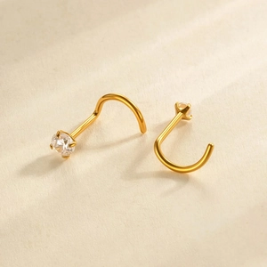 Pair of gold G23 titanium L-shaped nose studs with sparkling cubic zirconia stones