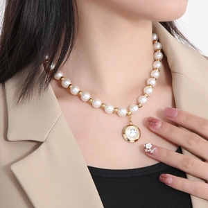French style pearl necklace with gold beads and crystal pendant shown on model