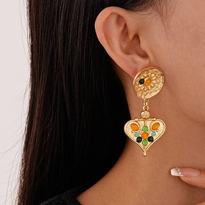 Close-up of vintage heart flower earrings with colorful resin beads on model