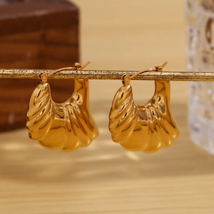 Modern 18K gold-plated hollow wing earrings with a unique textured striped finish