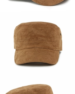 Close-up of brown suede cadet cap showing fine stitching and metal ventilation eyelet