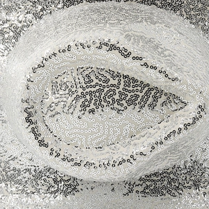 Macro shot of shimmering silver sequins and textured pattern on a festive cowboy hat
