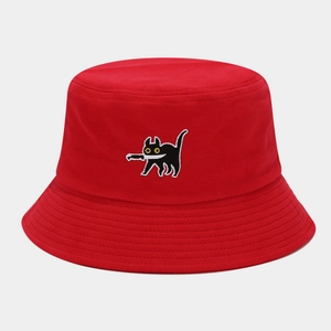 Close-up of funny cat embroidery with a knife on a red cotton canvas bucket hat