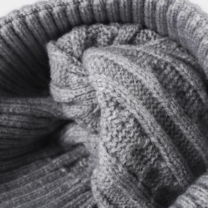 Gray chunky knit beanie with classic cable pattern and ribbed hem for winter warmth