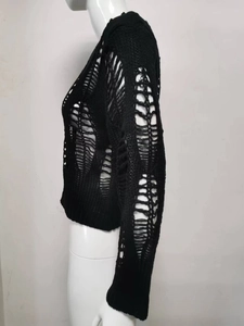 Detail view of black distressed knit sweater featuring gothic hollow-out ripped textures