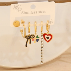 Set of six gold stainless steel earrings with clover and heart charms on display