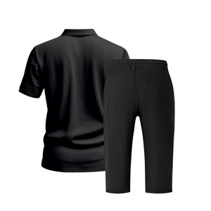Rear view of black waffle knit polo shirt and cropped pants set on a white background