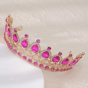 Detail of luxury bridal tiara with pink teardrop stones and crystals on white fur
