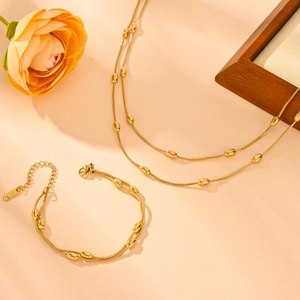 Ensemble collier double rang et bracelet en acier inoxydable avec perles dorées ovales