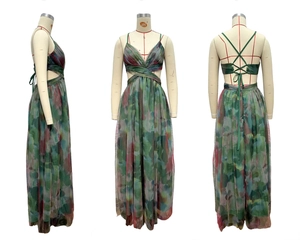 Detail view of colorful tie-dye mesh maxi dress showing cutout waist and crisscross back straps