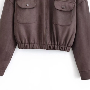 Detail of dark brown faux suede jacket featuring utility pockets and elastic drawstring hem