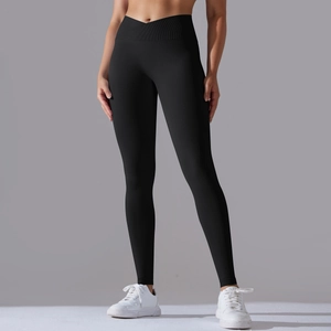 Detail view of high waisted black yoga leggings with V-shaped crossover waist design