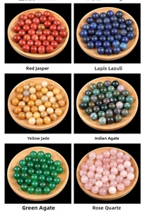 Macro display of assorted semi-precious stone beads including red jasper and rose quartz