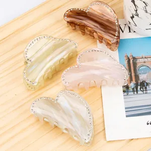 Set of four 8cm heart-shaped acetate hair claws with rhinestones in various colors