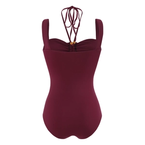 Detail of burgundy one-piece swimsuit featuring wooden beads and ruched chest design