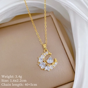 Golden moon and heart pendant necklace with zircon stones and product dimensions detail