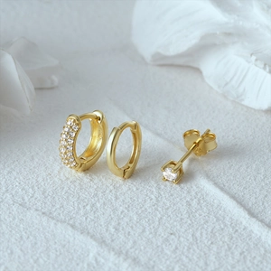 Detailed macro view of S925 sterling silver gold earrings with clear 925 hallmarks