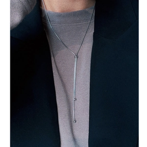 Minimalist silver long snake chain necklace in durable titanium steel worn by a model