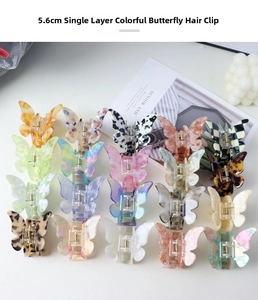 Detailed view of colorful 5.6cm butterfly hair clips in various marble and floral patterns