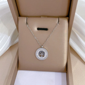 Macro detail of silver tree of life pendant with sparkling rhinestones in a jewelry box