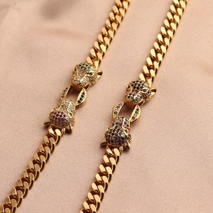 Gold Cuban chain bracelet featuring dual leopard heads with multicolor micro-pave stones