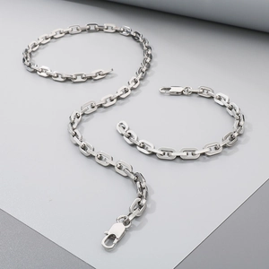 Detailed close-up of silver square link chain necklace and bracelet DIY craft set