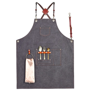 Durable dark grey canvas apron with brown leather straps and multi-pocket design for barbers