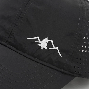 Detail of mountain embroidery and laser-cut eyelets on black quick-dry baseball cap