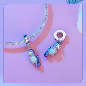 Macro shot of S925 sterling silver seahorse charm with blue gradient enamel and zircon