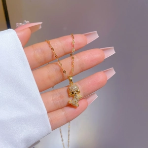 Sparkling pavé puppy pendant necklace in 18k gold plating featuring white cubic zirconia