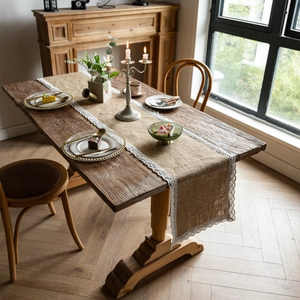 Rustic jute table runner with delicate white lace trim on a cozy wooden dining table
