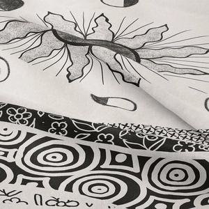Macro shot of Nordic cactus tapestry fabric with detailed black and white ethnic pattern