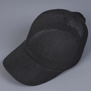 Detail of black breathable knit mesh baseball cap showing textured woven fabric structure